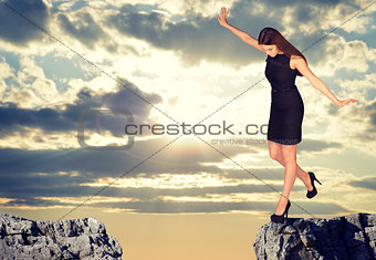 Businesswoman standing on the edge of rock gap