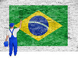 House painter covers brick wall with flag of Brazil