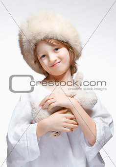 Portrait of a Boy with Fluffy Hat and Stuffed Animal 