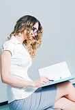 Beautiful young business woman working with documents