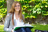 Pretty female universtity student studying outdoor