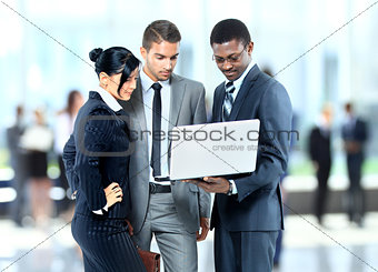 Happy business man holding a modern laptop