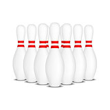 Bowling pins with red stripes standing in formation