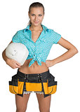 Pretty girl in shorts, shirt and tool belt holding white helmet