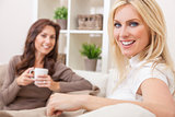 Two Women Friends Drinking Tea or Coffee at Home