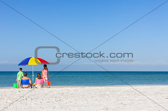 Family Alone on Beach With Umbrella