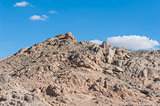 Rocky desert mountain with blue sky background
