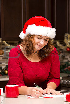 woman writing Christmas card