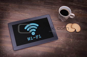 Tablet with Wi-Fi connection on a wooden desk