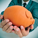 man in suit with a piggy bank