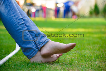 Woman Barefoot Legs on the Green Grass in Garden
