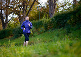 Young Beautiful Woman Running in the Park