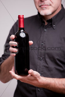 bottle of red wine and hands of a man