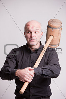 suspect man with a wooden big hammer