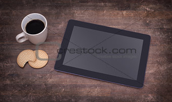 Tablet touch computer gadget on wooden table
