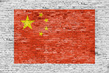 Flag of China painted over brick wall