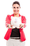 Business woman with a piggy bank