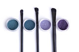 Top view of mineral eye shadows in pastel colors and brushes