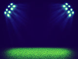 Spotlights illuminating area of grass court