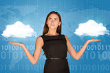 Businesswoman holding two white clouds, as if chosing