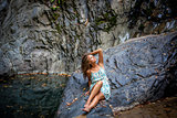 beautiful girl posing in dress at the waterfall