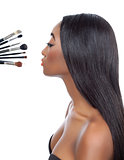 Black woman with straight hair and makeup brushes