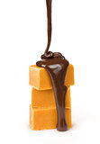 melted chocolate is poured on a stack of slices of milk and dark chocolate and white chocolate