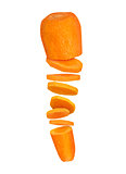 Carrots cut into pieces in the air on a white background