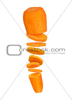 Carrots cut into pieces in the air on a white background