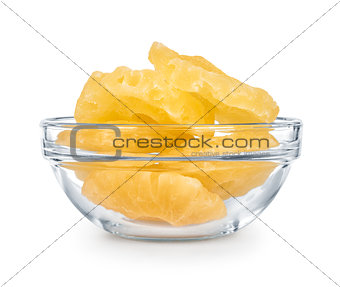 Dried pineapple in a glass bowl isolated on white background