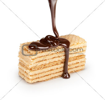on vanilla wafer pouring chocolate on white background