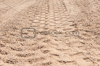 Closeup of 4x4 tyre tracks in the desert