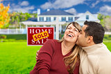 Mixed Race Couple in Front of Sold Real Estate Sign
