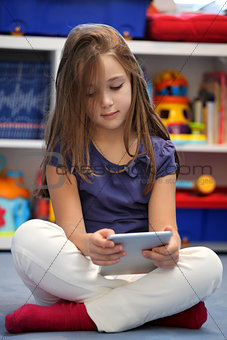 Happy pre-teen girl using a digital tablet computer