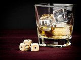 dice near whiskey glass, concept of game