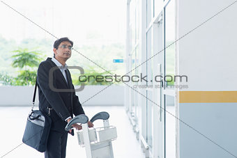 Indian businessman with airport trolley