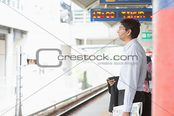 Indian businessman waiting train