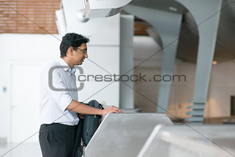 Indian man at airport check in counter