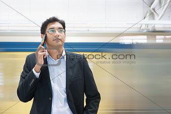 Talking on phone at train station