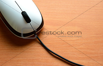 White Wired Computer Mouse on a Wooden Table