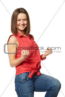 Pretty brunette in blue jeans and a red shirt on white background