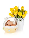 Fresh yellow tulips and eggs in bowl
