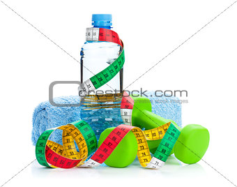 Two green dumbells, tape measure and drink bottle