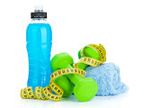 Two green dumbells, tape measure and drink bottle