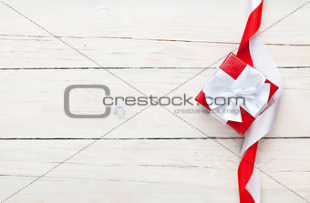 Valentines day background with gift box over white wooden table
