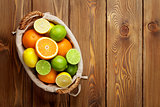 Citrus fruits in basket. Oranges, limes and lemons