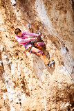 Young female rock climber on a cliff face