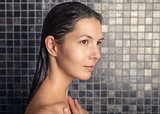 Attractive woman washing her hair in the shower