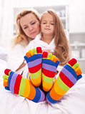 Woman and little girl wearing funny socks