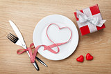 Valentine's Day heart shaped red ribbon over plate